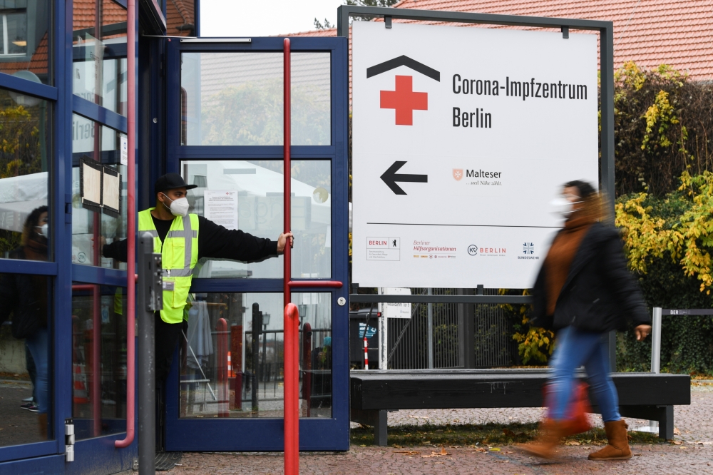 A woman walks to a coronavirus disease (COVID-19) vaccination center at 