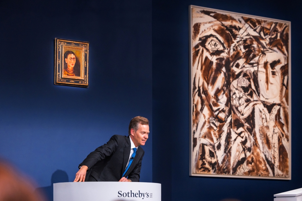 Auctioneer Oliver Barker, Chairman of Sotheby's Europe, sells a Frida Kahlo self portrait for $34.9 Million USD during an art auction, in the Manhattan borough of New York City, New York, U.S., November 16, 2021. Julian Cassady/SOTHEBY'S/Handout via REUTERS