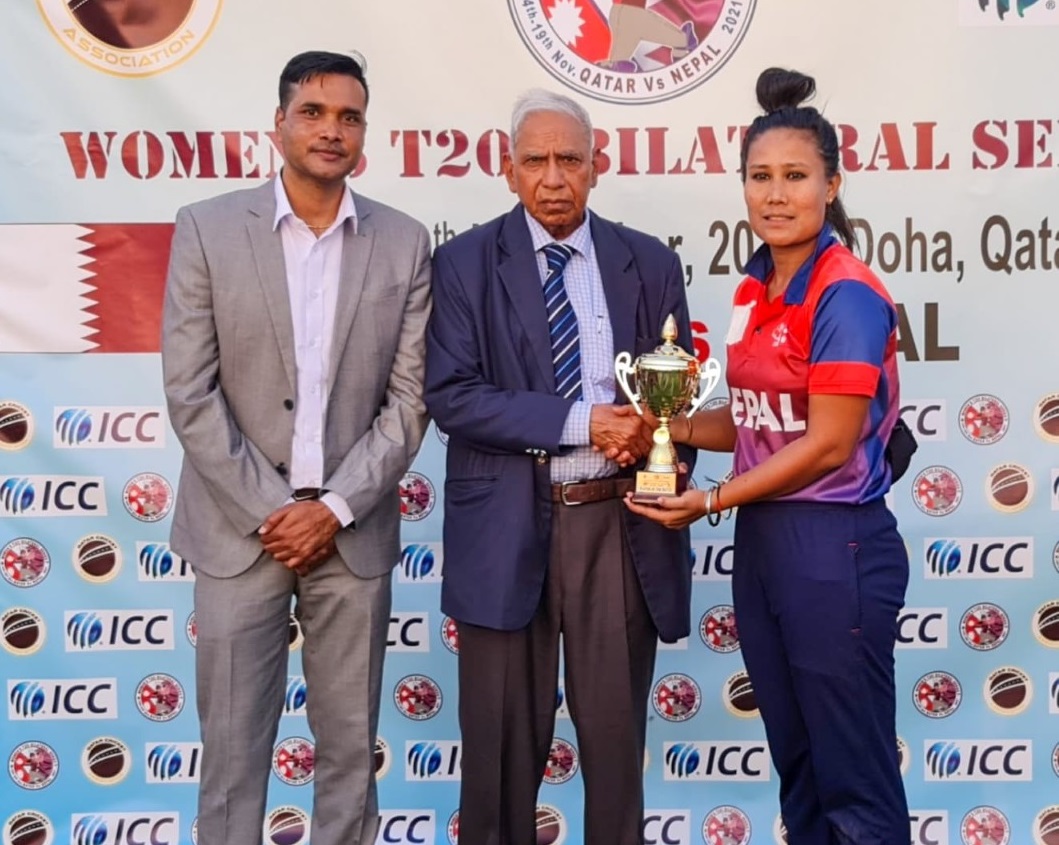 Qatar Cricket Association Operations Manager Manzoor Ahmad hands best player of the match award to Nepal's Rubina Chhetry.