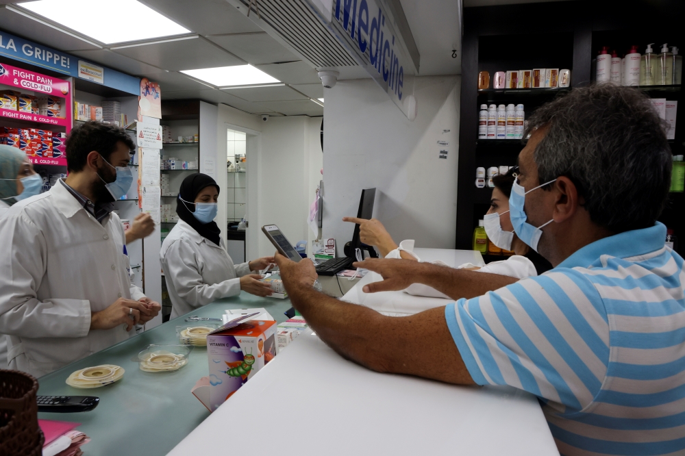 Customers buy medication inside a pharmacy in Beirut, Lebanon November 17, 2021. Picture taken November 17, 2021. Reuters/Mohamed Azakir
