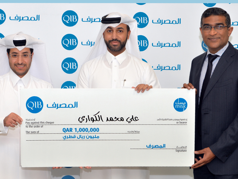 Winner of the 4th edition of Misk Account annual draw with QIB officials.