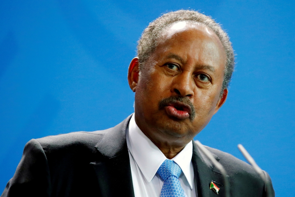 FILE PHOTO: Sudan's Prime Minister Abdalla Hamdok and German Chancellor Angela Merkel (not pictured) address the media at the Chancellery in Berlin, Germany, February 14, 2020. REUTERS/Hannibal Hanschke/File Photo