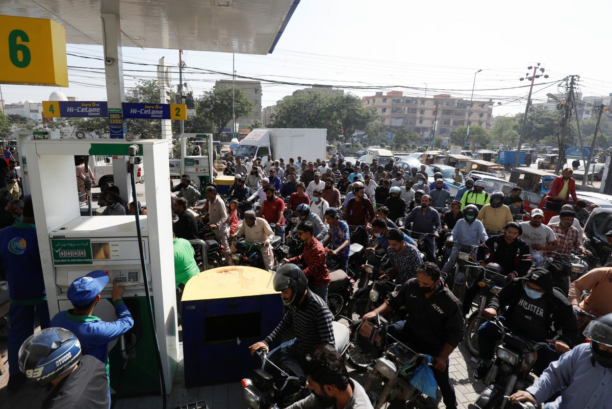 People on motorcycles wait for their turn to get petrol at a petrol station, after Pakistan Petroleum Dealers Association (PPDA) announced a countrywide strike, in Karachi, Pakistan, November 25, 2021. REUTERS/Akhtar Soomro
