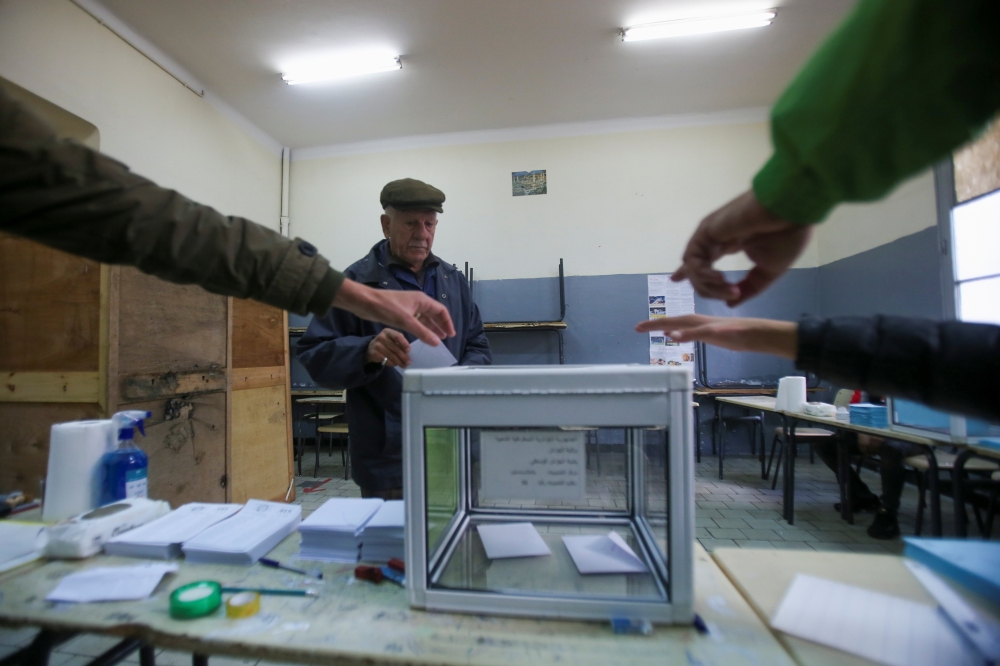 People point at the ballot box as a man walks to cast his vote during the local elections, in Algiers, Algeria November 27, 2021. REUTERS/Ramzi Boudina