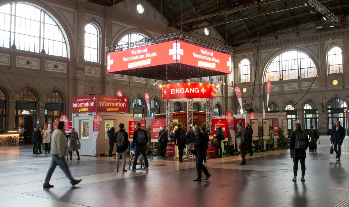 FILE PHOTO: People walk at the so-called 'vaccination village' (Impfdorf) after the start of a countrywide COVID-19 vaccination week against the coronavirus disease, in the hall of the central railway station, in Zurich, Switzerland November 8, 2021. REUTERS/Arnd Wiegmann/File Photo
