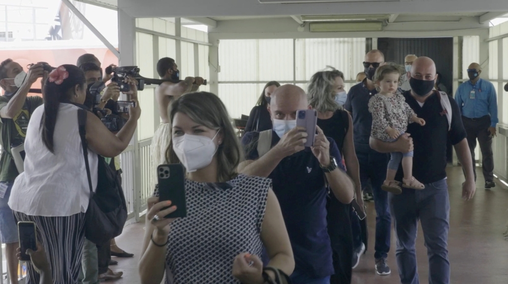Travellers walk in the terminal upon arrival at Nadi Airport, Fiji in this still frame obtained from handout video dated December 1, 2021. FIJI AIRWAYS /Handout via REUTERS