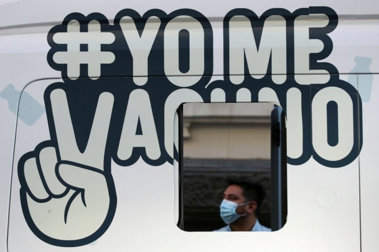 A man waits outside a mobile vaccination centre to receive a dose of Sinovac's CoronaVac coronavirus disease (COVID-19) vaccine in Santiago, Chile May 24, 2021. The sign reads ''I get vaccinated