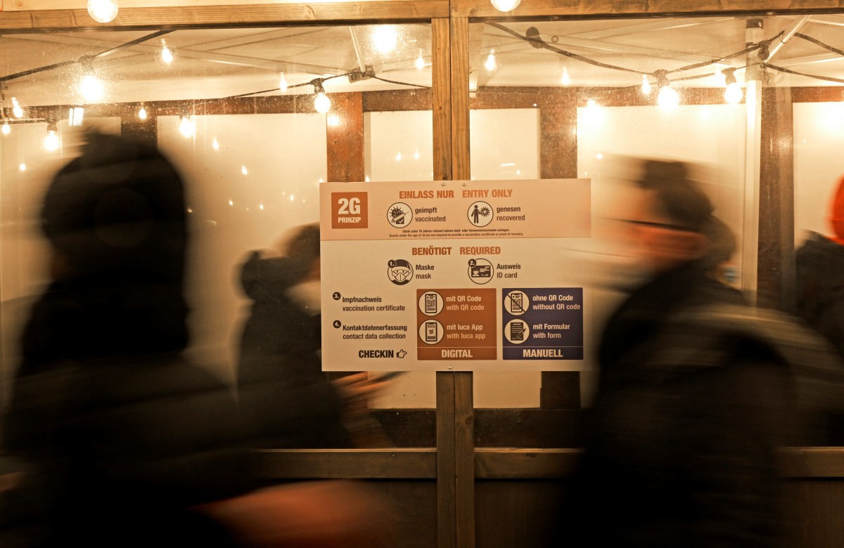 People queue to enter a Christmas market open only for visitors who are vaccinated or recovered from the coronavirus disease (COVID-19) at the red-light district 