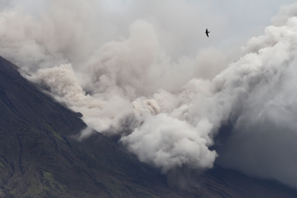 Ashes and clouds spew from Mount Semeru volcano as seen from Pronojiwo, Lumajang, East Java province, Indonesia December 6, 2021, in this photo taken by Antara Foto/Ari Bowo Sucipto/via REUTERS