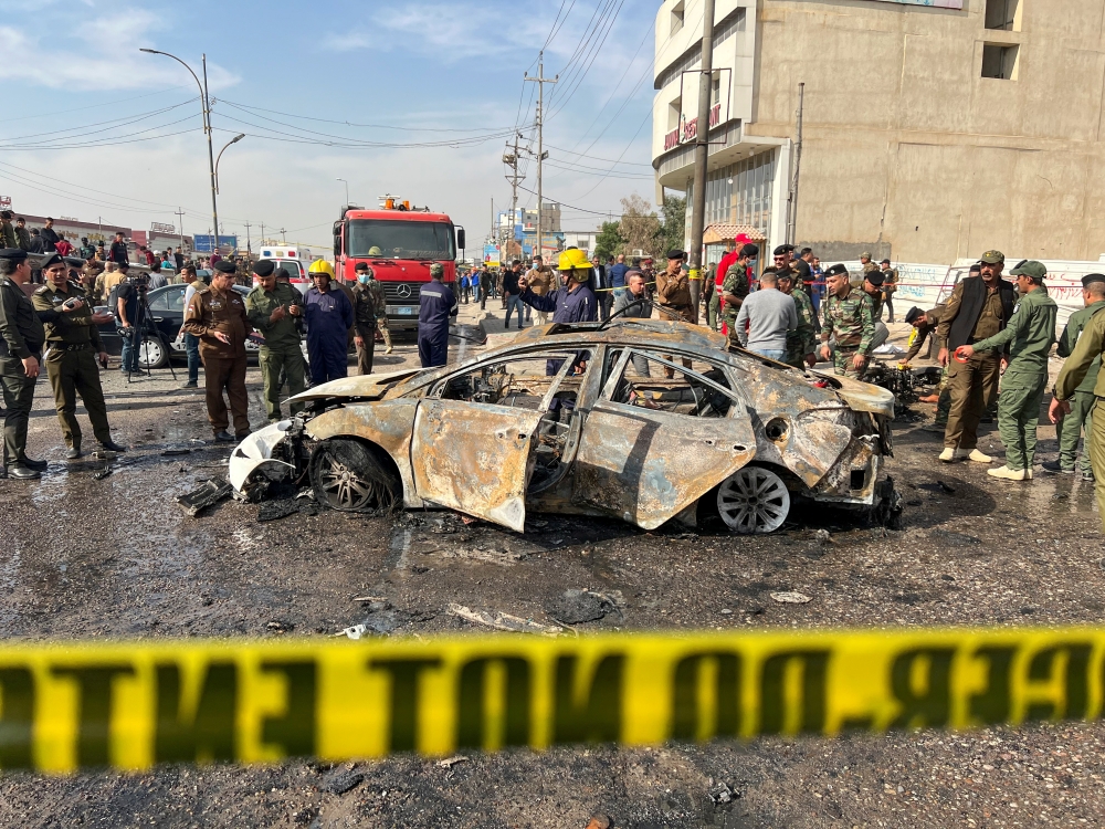 Iraqi security forces inspect the site of an explosion in Basra,Iraq December 7, 2021. Reuters/Mohammed Aty