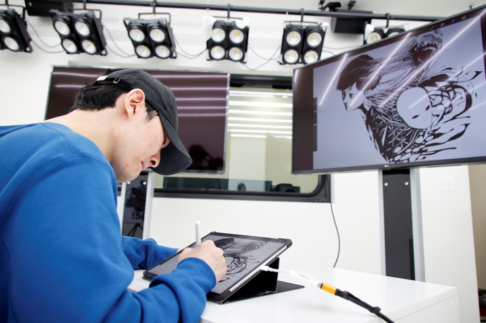 Hongjacga, cartoonist of Kakao Webtoon Dr. Brain, draws after an interview with Reuters at a company studio in Seongnam, South Korea, December 1, 2021. Picture taken December 1, 2021. REUTERS/Heo Ran