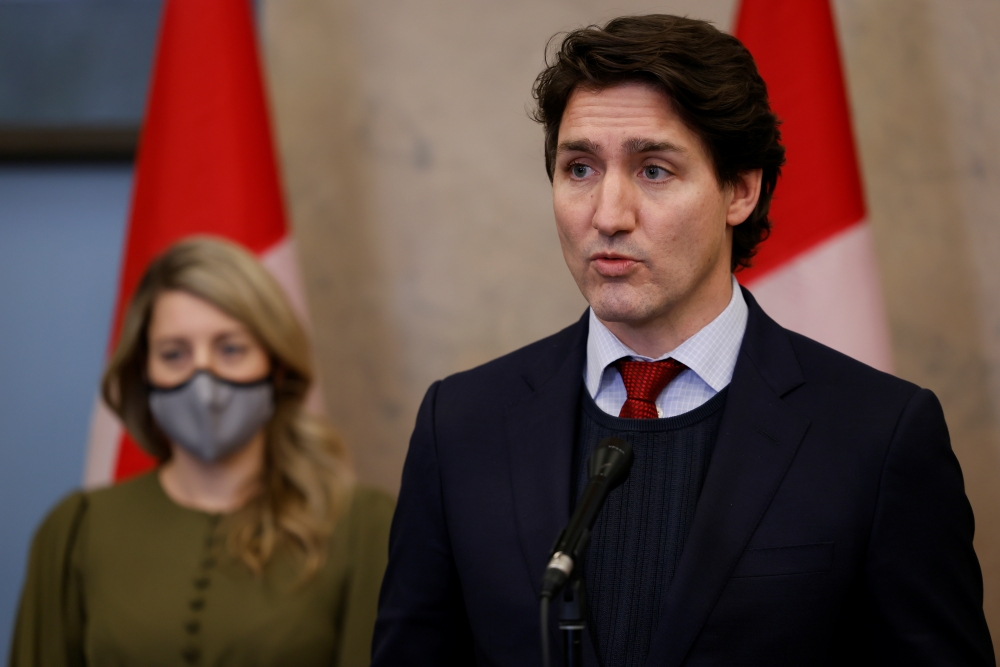 Canada's Prime Minister Justin Trudeau, with Minister of Foreign Affairs Melanie Joly, speaks during a press conference on Parliament Hill in Ottawa, Ontario, Canada, December 8, 2021. Reuters/Blair Gable