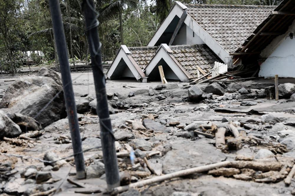 Houses that submerged with lava are seen in Kamar Kajang, an area affected by the eruption of Mount Semeru volcano, in Candipuro district, Lumajang, East Java province, Indonesia, December 9, 2021. REUTERS/Willy Kurniawan