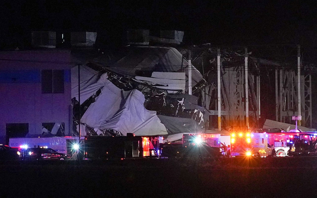 Emergency vehicles surround the site of an Amazon distribution warehouse with a collapsed roof, after storms hit the area of Edwardsville, Illinois, U.S. December 10, 2021. REUTERS/Lawrence Bryant
