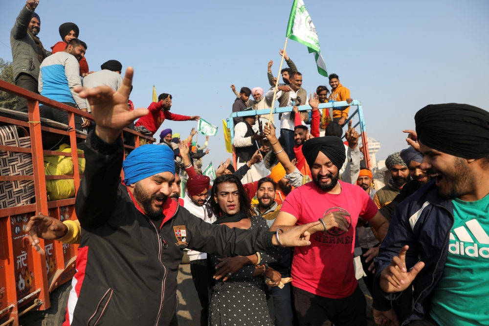 Farmers dance as they vacate a protest site, after the government agrees to their demands, including assurance to consider guaranteed prices for all produce, at the Singhu border near New Delhi, India, December 11, 2021. REUTERS/Anushree Fadnavis