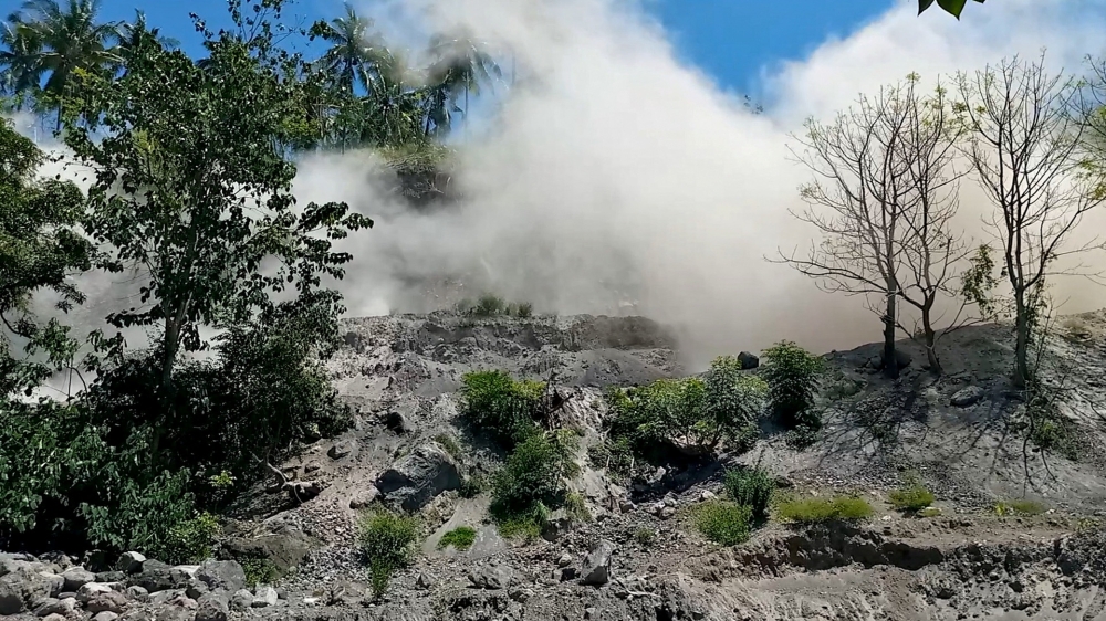 A still image from a social media video shows dust disturbances on side of hill after an earthquake in Nagekeo, East Nusa Tenggara, Indonesia December 14, 2021. Alldo Van Robby/via REUTERS