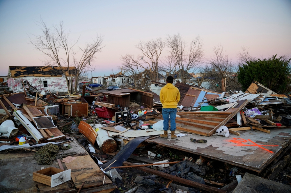 Nicolaus Kruse, 23, stands amongst the rubble of the home he grew up in after a devastating outbreak of tornadoes ripped through several U.S. states, in Mayfield, Kentucky, U.S. December 13, 2021. REUTERS/Cheney Orr