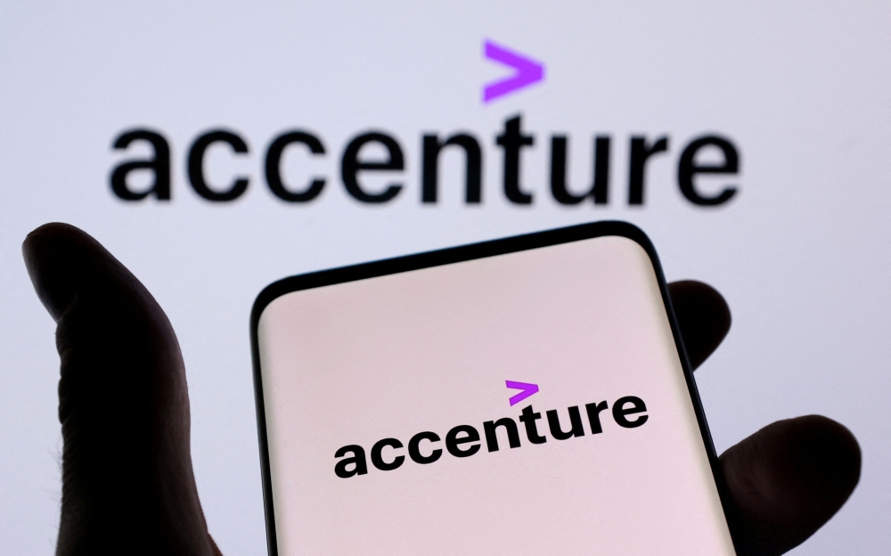 Accenture PLC logo is seen on a smartphone in front of displayed same logo in this illustration taken, December 1, 2021. REUTERS/Dado Ruvic/Illustration/File Photo