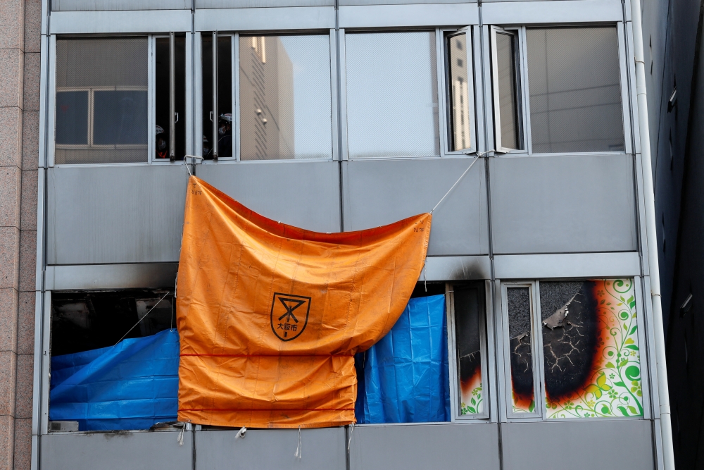 Firefighters work at a building where a fire broke out, in Osaka, Japan December 18, 2021. Reuters/Kim Kyung-Hoon