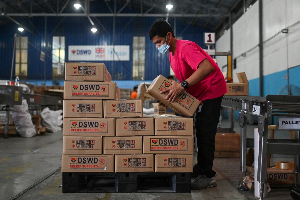 A worker prepares relief goods for people affected by typhoon Rai, at a government warehouse in Pasay City, Metro Manila, Philippines, December 17, 2021. Reuters/Lisa Marie David