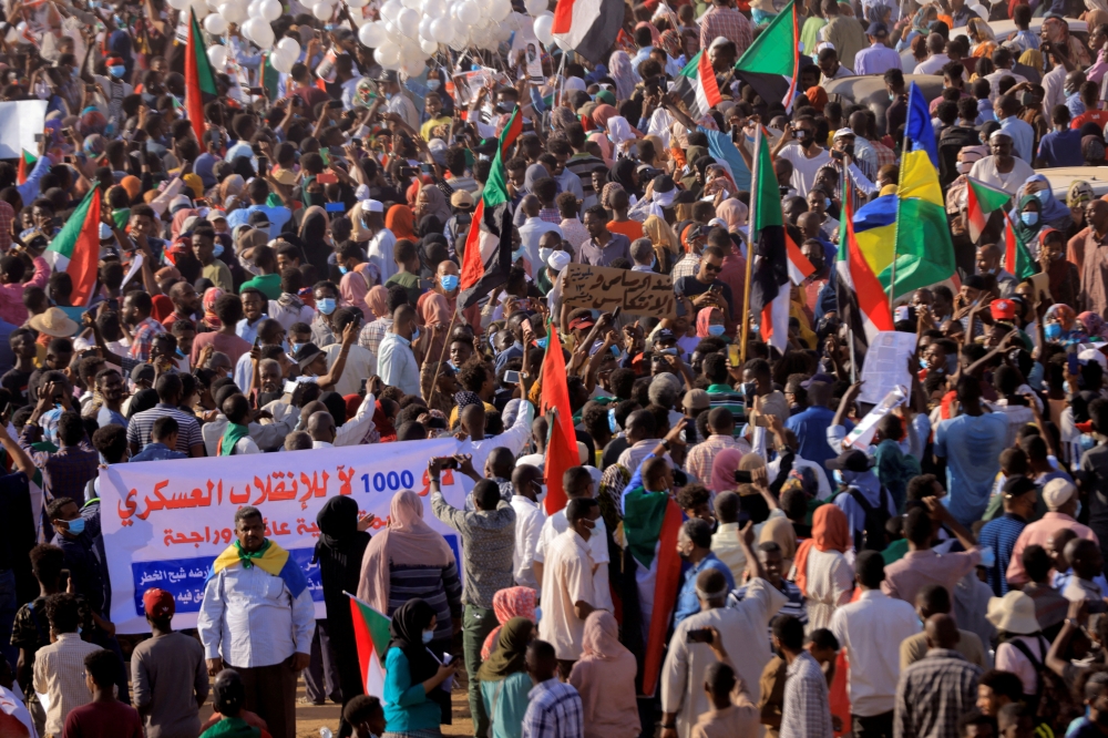 Protesters march during a rally from Khartoum North to Omdurman against military rule following last month's coup, in Khartoum, Sudan. December 13,2021. REUTERS.