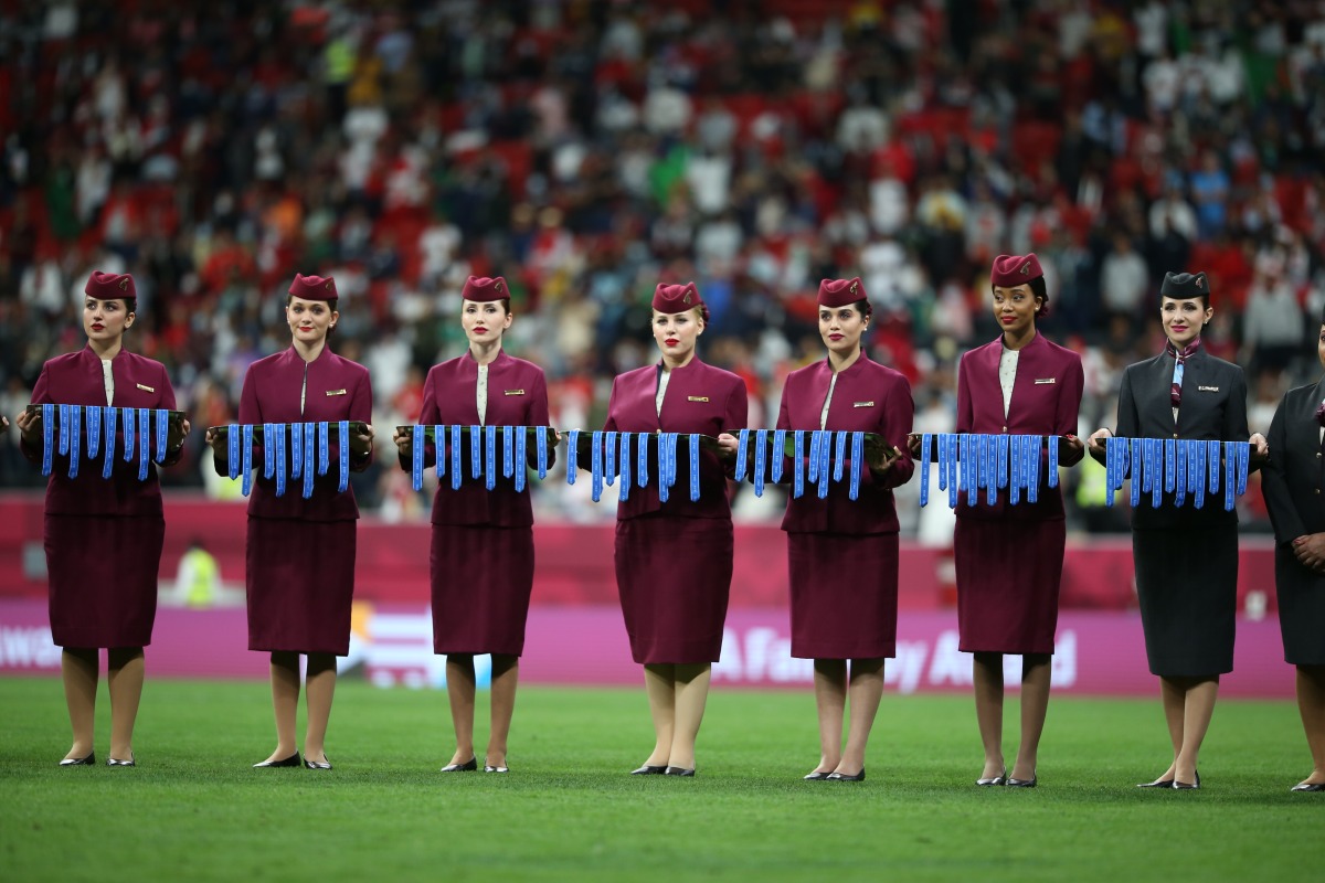 Qatar Airways hostesses carry the FIFA Arab Cup medals following final match between Tunisia and Algeria at Al Bayt Stadium, on Saturday.