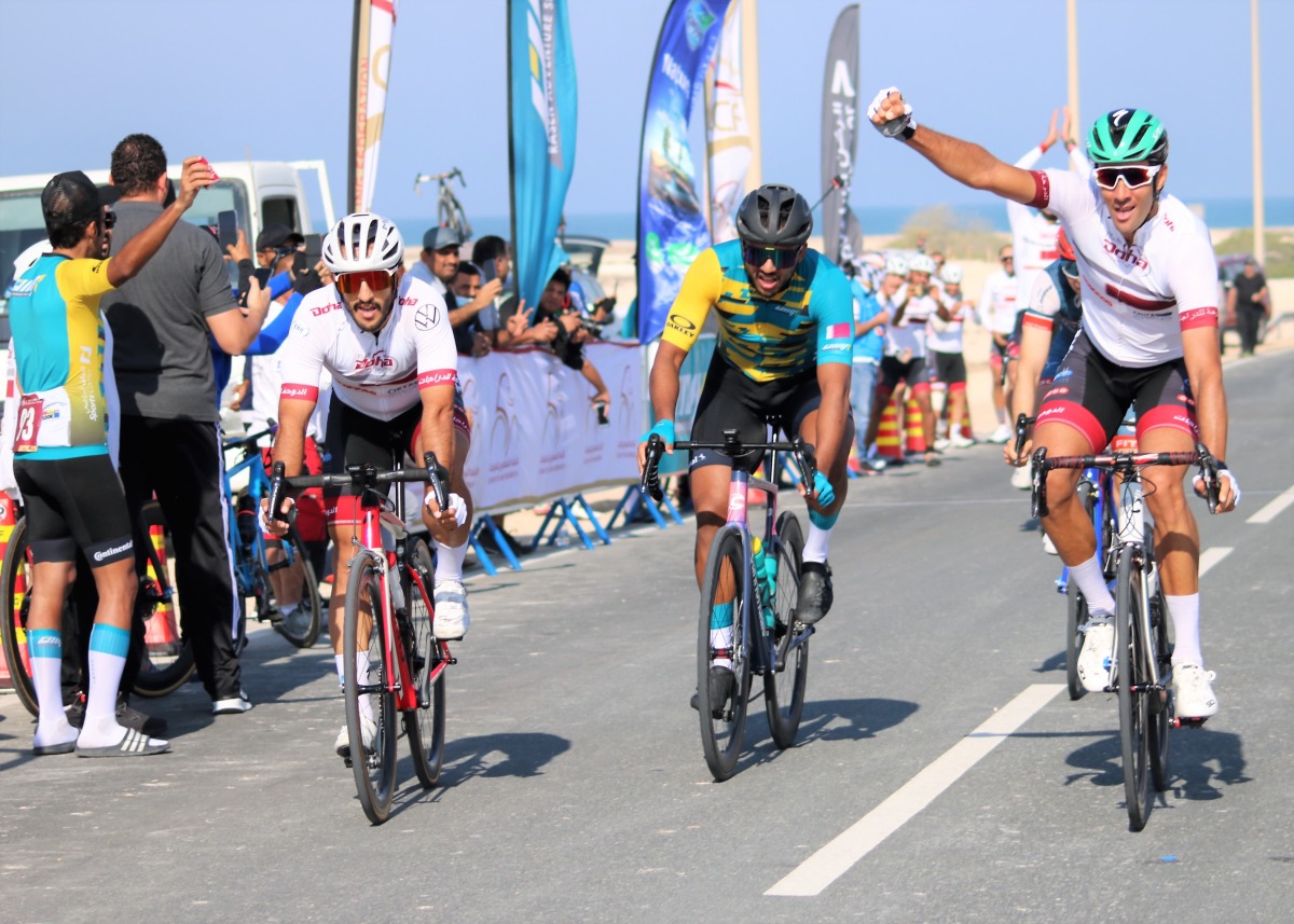 Competitors cross the finish line during the Dukhan Road Race.