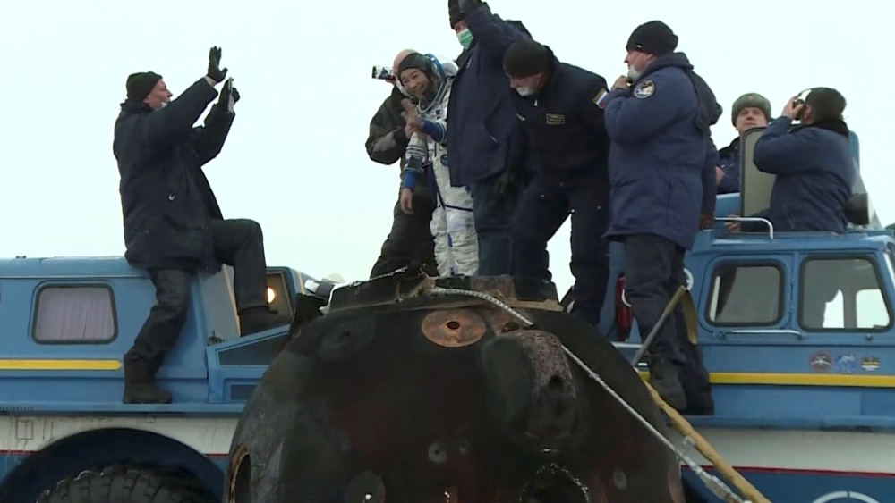 Ground personnel assists Japanese entrepreneur Yusaku Maezawa shortly after landing of the Soyuz MS-20 space capsule in a remote area outside Zhezkazgan, Kazakhstan December 20, 2021, in this still image taken from video. Roscosmos/Handout via Reuters