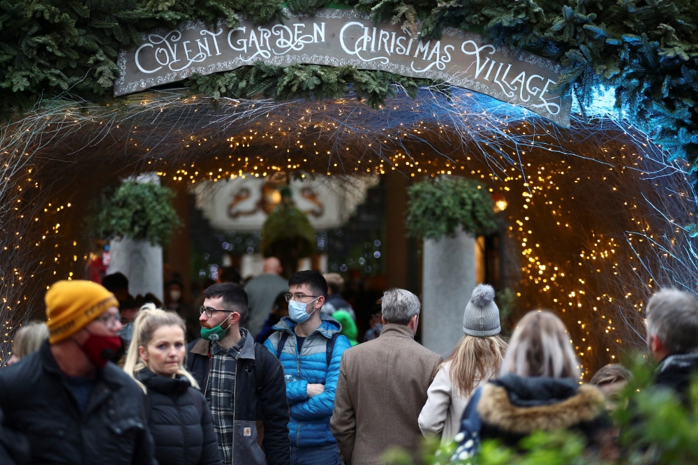 People visit the Covent Garden Christmas Village, in London, Britain, December 20, 2021. REUTERS/Hannah McKay
