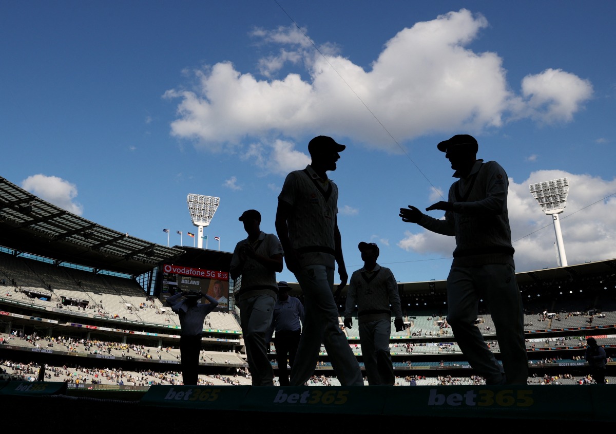 Australia players walk off the pitch after the end of the day REUTERS/Loren Elliott
