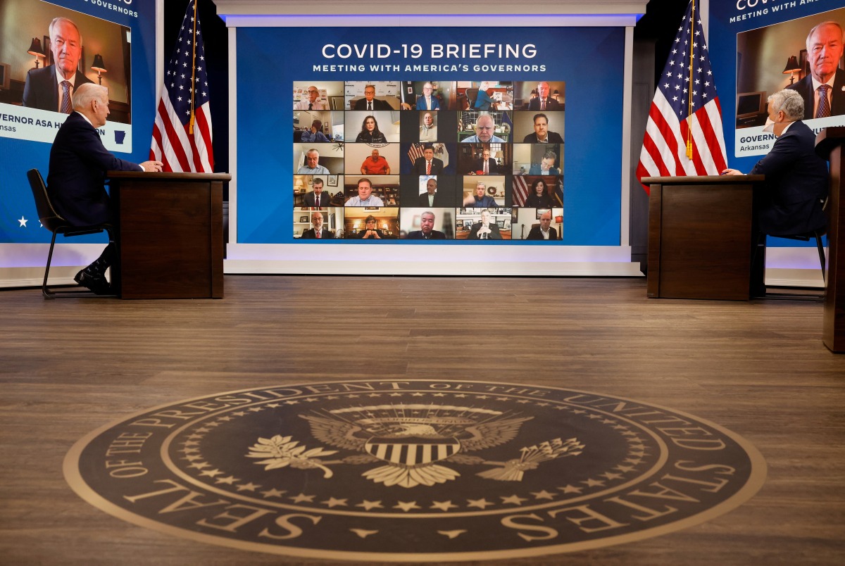 U.S. President Joe Biden and his COVID-19 Response Team, Jeff Zients, COVID-19 Response Coordinator and Dr. Anthony Fauci, White House Chief Medical Advisor, hold their regular call with the National Governors Association to discuss his Administration's response to the Omicron variant and to hear from the Governors on the needs in their States, in the South Court Auditorium at the White House, in Washington, U.S., December 27, 2021. REUTERS/Evelyn Hockstein
