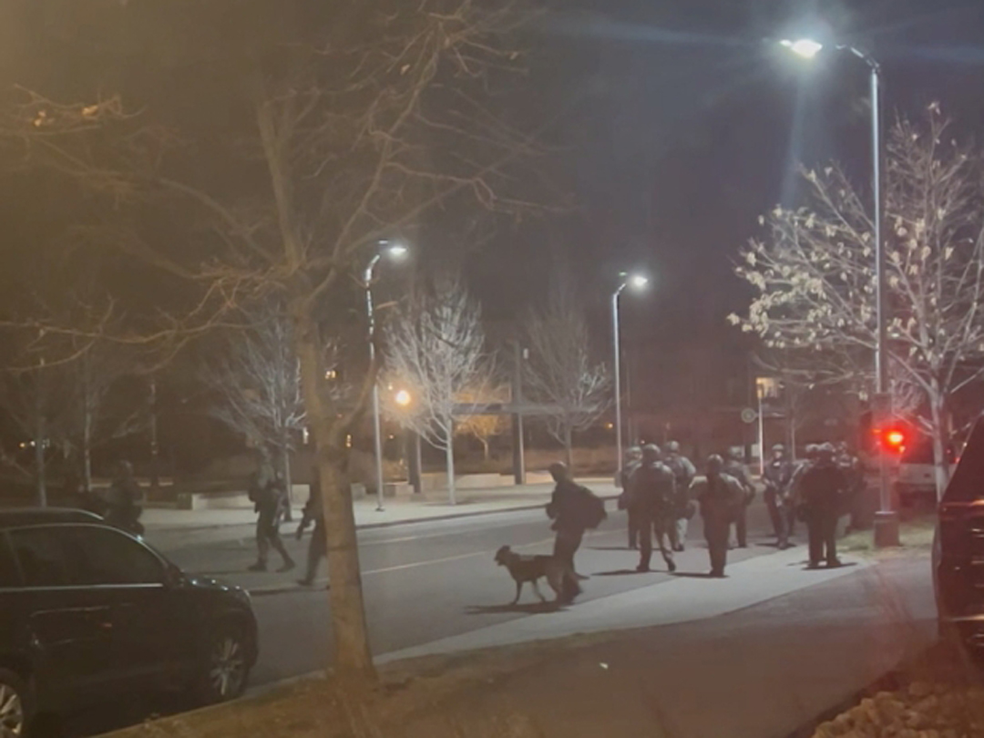 Officers gather in the street, in Lakewood, Colorado, U.S., December 27, 2021 in this still image taken from a social media video. Hawk Hawkins/via REUTERS