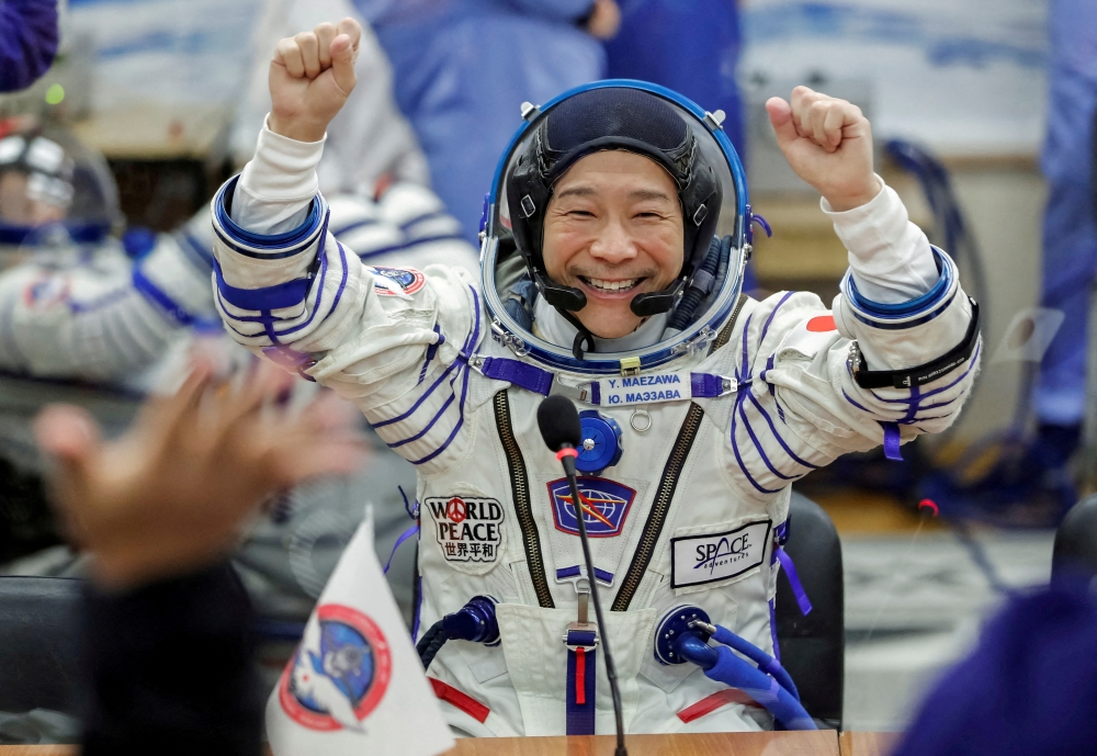 Japanese entrepreneur Yusaku Maezawa reacts as he speaks with his family after donning space suits shortly before the launch to the International Space Station (ISS) at the Baikonur Cosmodrome, Kazakhstan, December 8, 2021. REUTERS/Shamil Zhumatov/File Photo