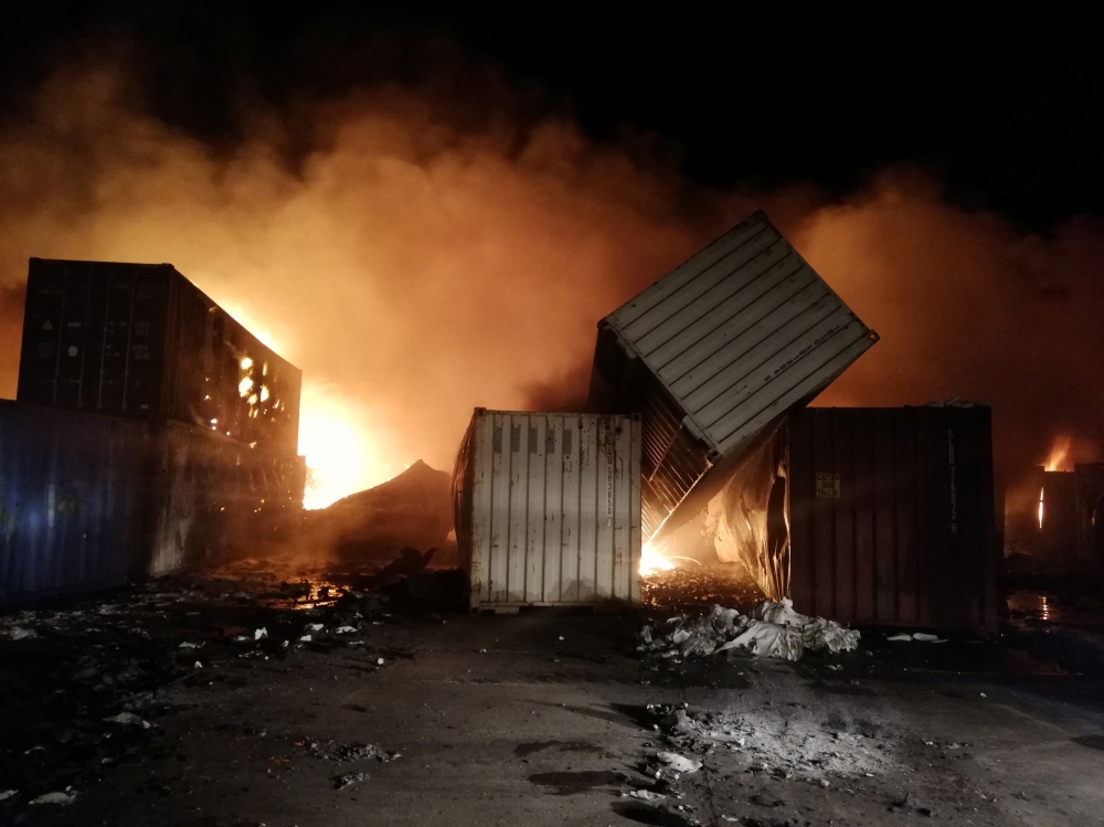 Smoke rises after Syrian state media reported an Israeli missile attack in a container storage area, at Syrian port of Latakia, Syria, in this handout picture released by SANA on December 28, 2021. 