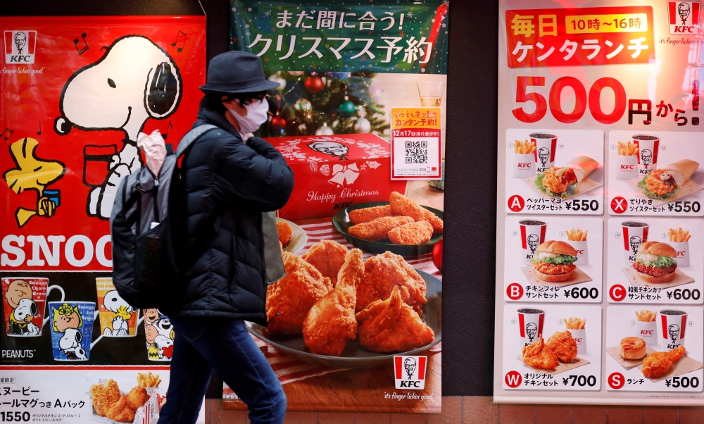 A man wearing a protective mask, amid the coronavirus disease (COVID-19) outbreak, walks past a Kentucky Fried Chicken (KFC) restaurant in Tokyo, Japan, December 14, 2021. REUTERS/Kim Kyung-Hoon/File Photo