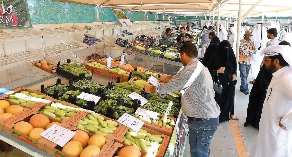 People buying local vegetables at a market.
