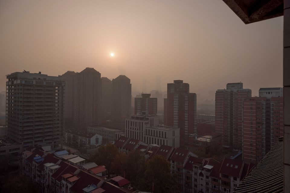 The sun rises over the city on a polluted morning in Beijing, China, November 18, 2021. REUTERS/Thomas Peter

