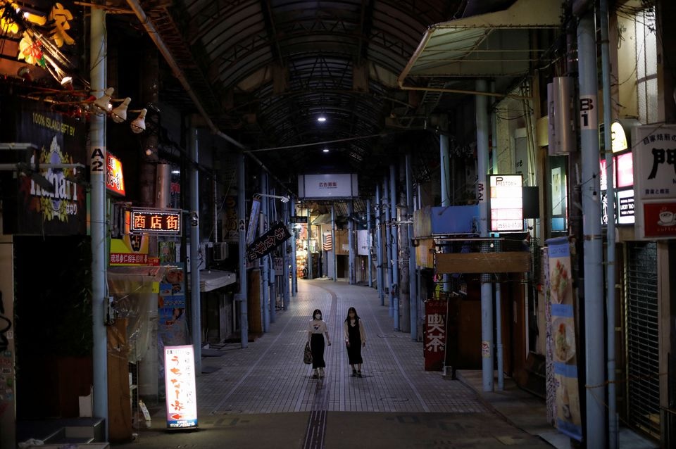 Passersby wearing protective face masks, amid the coronavirus disease (COVID-19) pandemic, walk at a shopping arcade in the prefectural capital Naha, on the southern island of Okinawa, Okinawa prefecture, Japan, October 24, 2021. Picture taken October 24, 2021. REUTERS/Issei Kato

