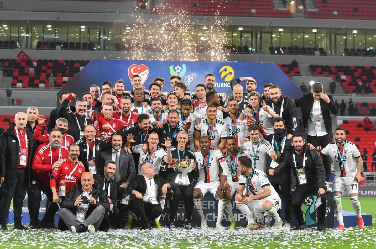 Besiktas players and officials celebrate with the trophy.
