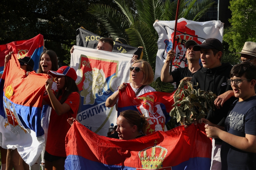 Supporters of Serbian tennis player Novak Djokovic rally outside the Park Hotel, where the star athlete is believed to be held while he stays in Australia, in Melbourne, Australia, January 6, 2022. Reuters/Loren Elliott