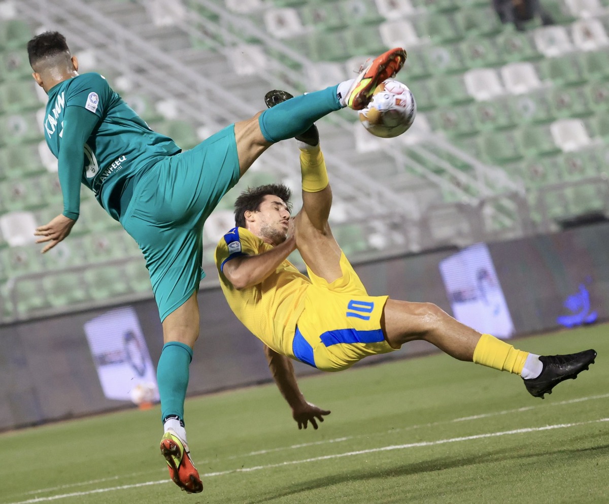 Action during the Round 13 match between Al Gharafa and Al Ahli, yesterday.