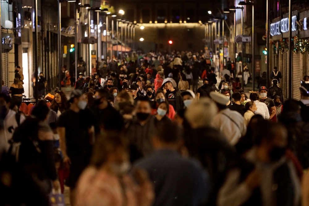People walk along Francisco I. Madero pedestrian street as the coronavirus disease (COVID-19) pandemic continues, in downtown Mexico City, Mexico January 5, 2022. Reuters/Luis Cortes

