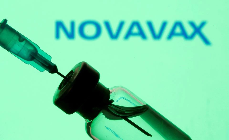 A vial and sryinge are seen in front of a displayed Novavax logo in this illustration taken January 11, 2021. REUTERS/Dado Ruvic/Illustration

