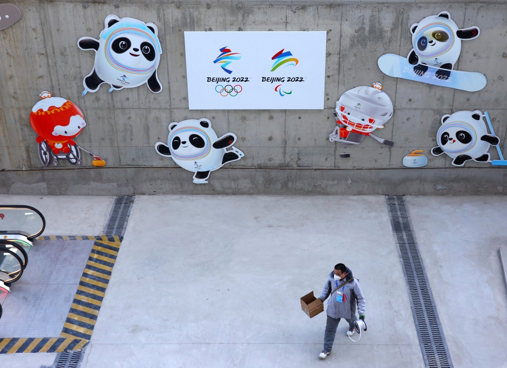 A worker walks outside the Main Press Centre ahead of the Beijing 2022 Winter Olympics in Beijing, China January 12, 2022. Reuters/Fabrizio Bensch