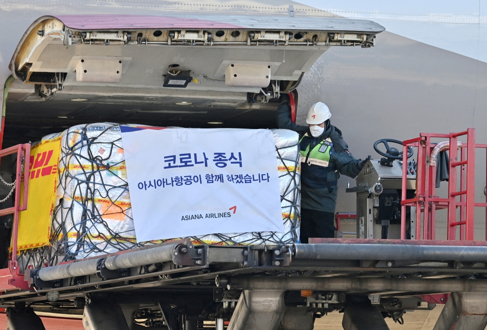 A worker unloads a cargo containing Pfizer's antiviral pill, Paxlovid at a cargo terminal of the Incheon International Airport, in Seoul, South Korea January 13, 2022. Jung Yeon-je /Pool via Reuters