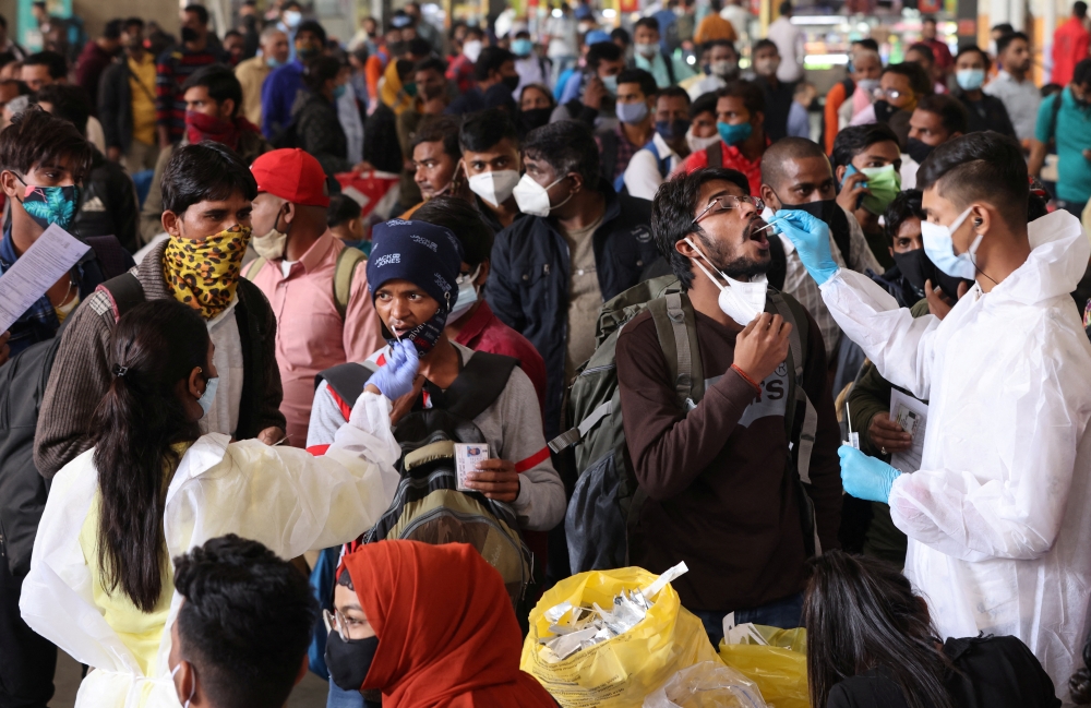 Health workers collect swab samples during a rapid antigen testing campaign for coronavirus disease (COVID-19), at a railway station in Mumbai, India, January 13, 2022. REUTERS/Francis Mascarenhas