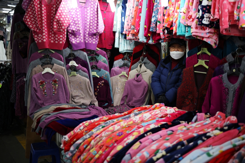 A shopkeeper waits for customers at a traditional market in Seoul, South Korea, January 14, 2022. REUTERS/Kim Hong-Ji