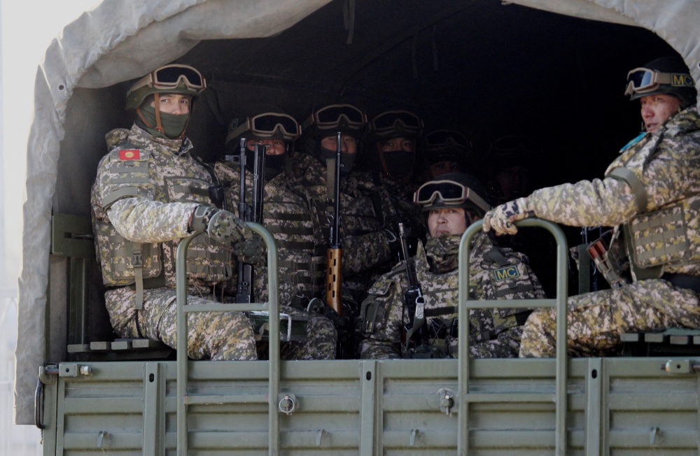 Kyrgyz servicemen of the Collective Security Treaty Organisation (CSTO) peacekeeping forces ride in the back of a military truck during their return from Kazakhstan, in Chui Region, Kyrgyzstan January 14, 2022. REUTERS/