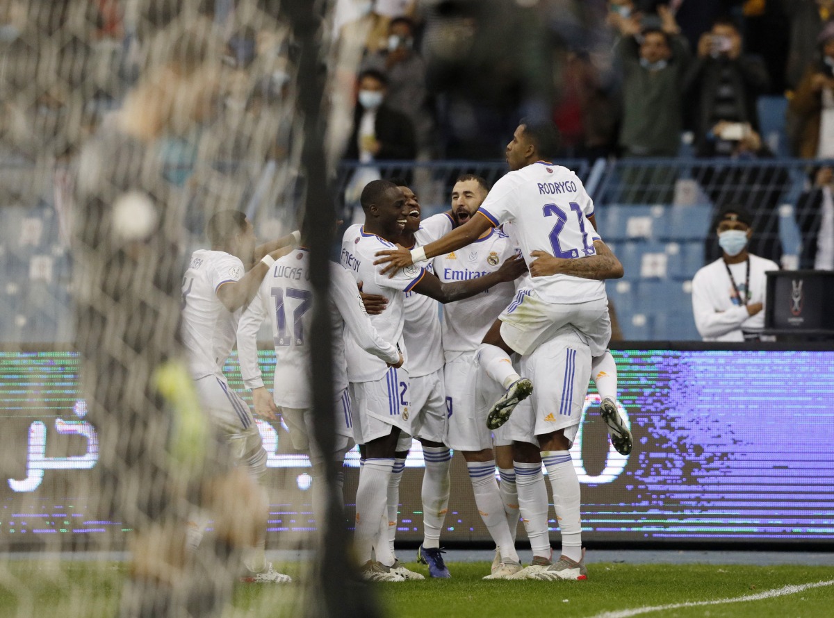 Real Madrid's Karim Benzema celebrates scoring their second goal with teammates REUTERS/Albert Gea