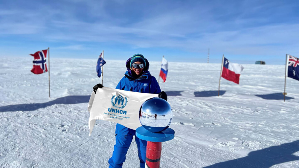 Sheikha Asma Al Thani at the South Pole, Antarctica, holding the UNHCR flag ©️ Nirmal Purja